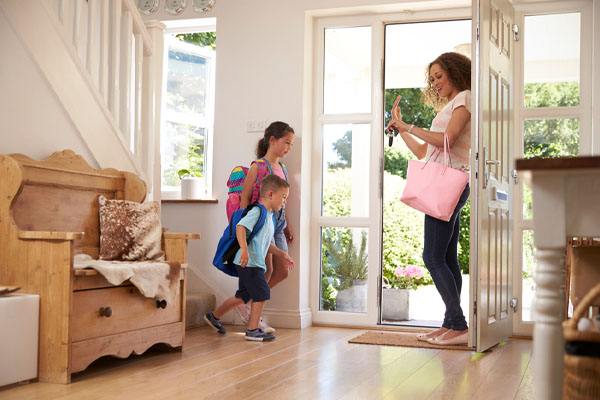 image of mother and children leaving house due without adjusting thermostat