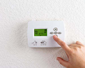 image of clinton ct homeowner with programmable thermostat