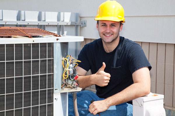 image of an HVAC contractor working on air conditioning system