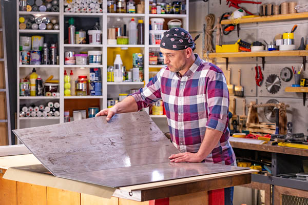 image of a man working in a home garage with ductless hvac system