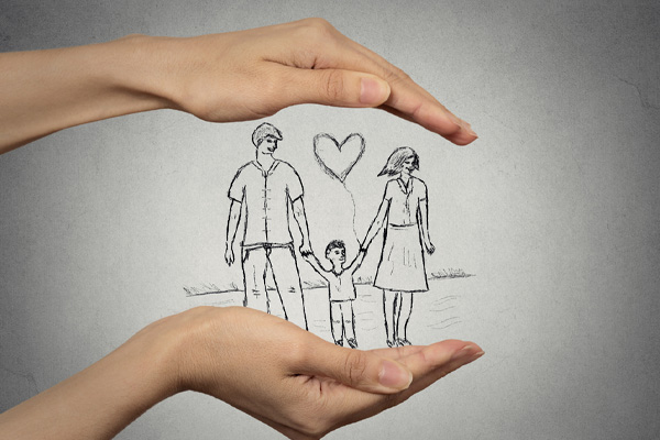 image of paper cut out of family in hands depicting heating oil safety