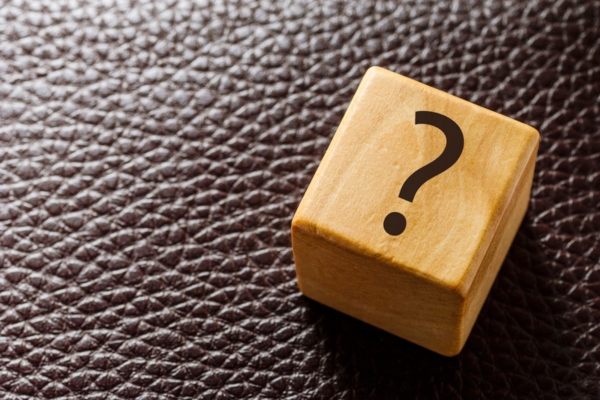 question mark on a wooden cube depicting HVAC Technology FAQs