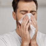 image of homeowner with allergies dealing with dry air in winter