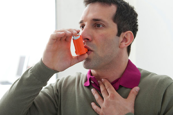 image of man with respiratory issues in winter and inhaler