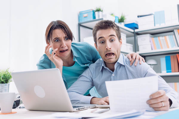 couple looking at energy costs and high cost of electrification