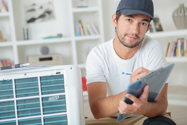 hvac contractor discussing heating and ac installation plans with homeowner