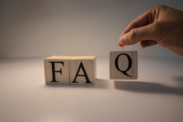 FAQ spelled using wooden letter cubes depicting questions about air conditioner noises