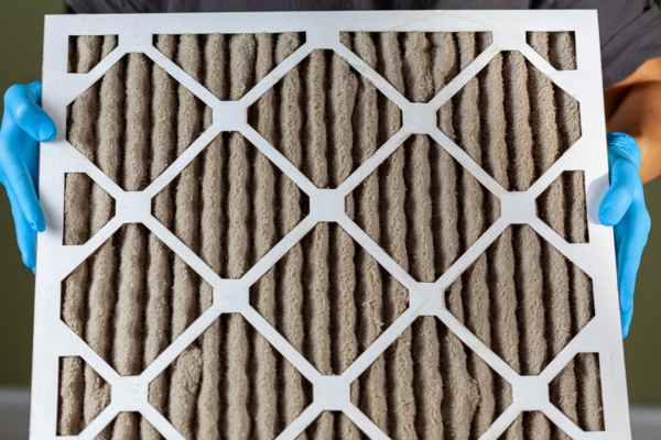 homeowner holding dirty HVAC filter