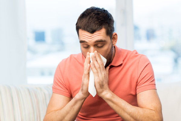 image of a homeowner experiencing allergies