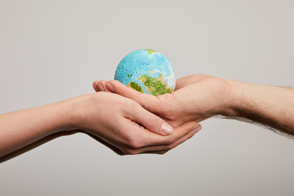 image of hands holding planet depicting bioheat renewable energy fuel