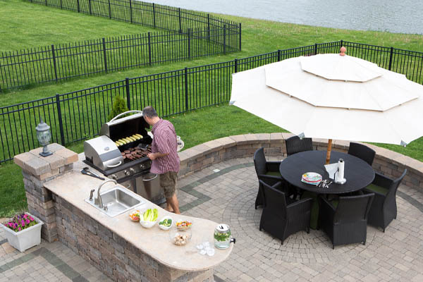 image of an outdoor kitchen with a propane grill