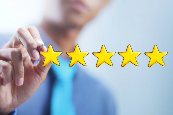 man blurred in the background drawing 5 stars depicting good SEER rating