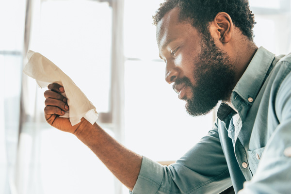 man suffering from high humidity at home due to mismatched ac units