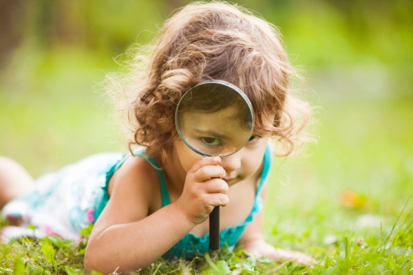 Kid with magnifying glass depicting Closer Look at Heating Efficiency Ratings