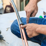 image of an hvac contractor performing an air conditioner installation