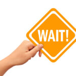 image of homeowner lifting wait sign depicting traditional heating system replacement