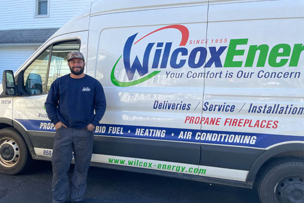 image of an hvac technician servicing an oil-fired home heating system