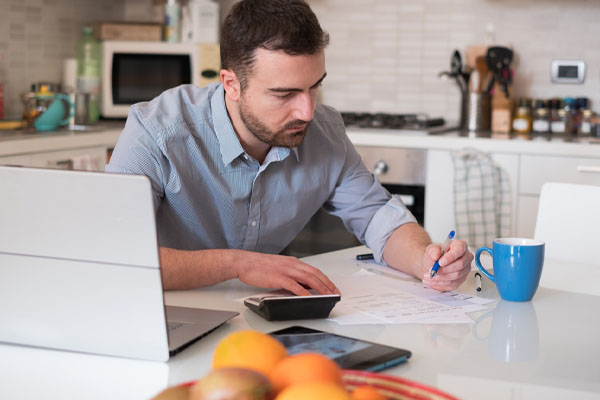 image of a homeowner calculating bills from cooling