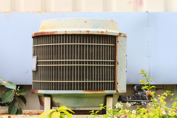 image of an old air conditioning unit that needs an AC unit replacement