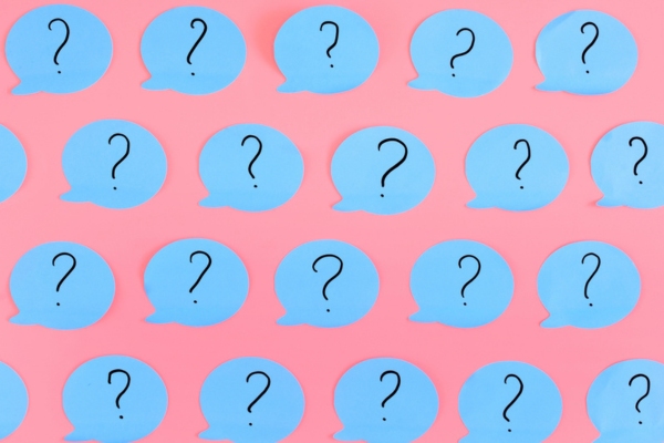 question marks on cutout thought bubble depicting FAQs about Ductless Air Conditioners for Oil-heated Homes