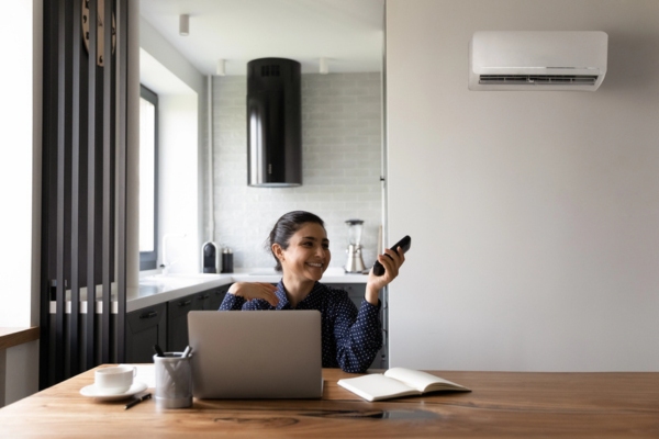 woman smiling while working at home depicting quiet operation of ductless air conditioner