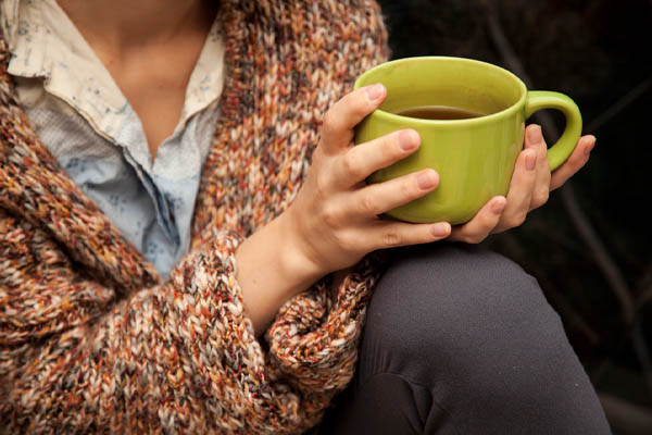 image of a homeowner drinking tea for warmth