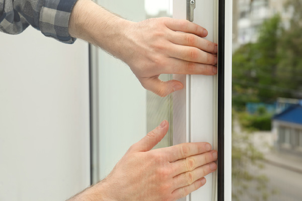 image of a homeowner sealing window