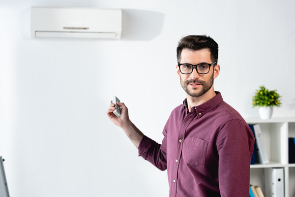 ductless heat pump and homeowner depicting ductless mini-split service life