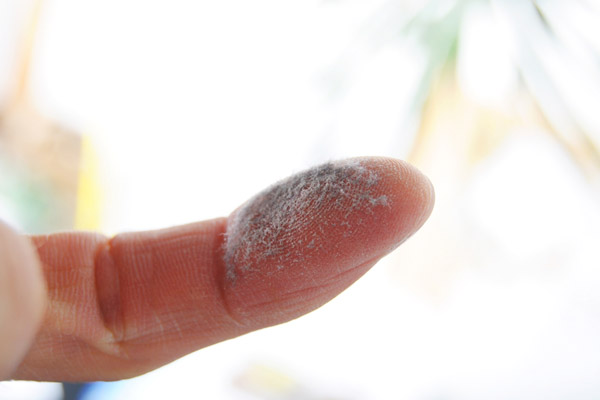 finger with dust on it depicting indoor air quality issues