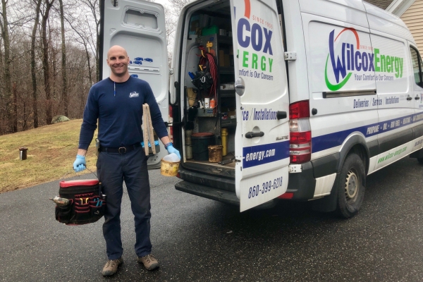 Wilcox Energy's reliable HVAC technician behind service van