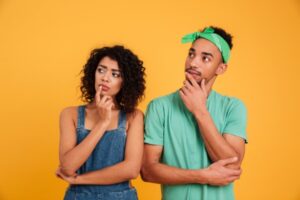 image of couple thinking about whether to repair or replace their air conditioner