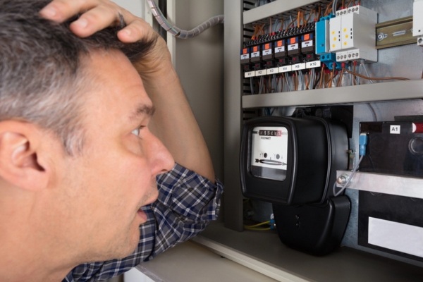 man shocked while looking at electric meter
