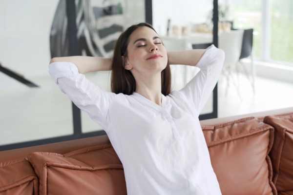 woman relaxing on couch depicting enhancing comfort and indoor air quality