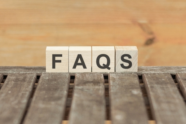 FAQS spelled using wooden letter cubes depicting questions about air conditioner replacement