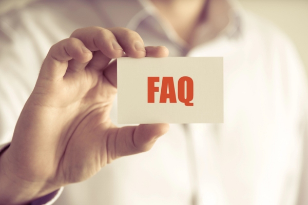 man holding a card that says FAQ depicting Old Air Conditioner questions