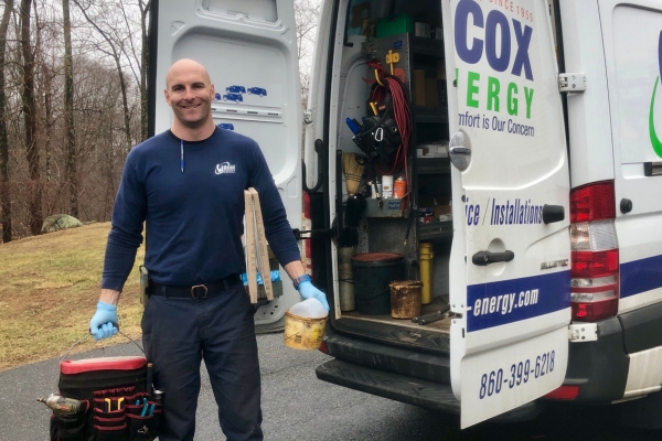 Wilcox Energy HVAC technician behind the service van