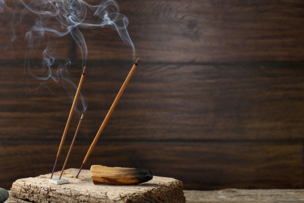 incense sticks lit up on a table depicting Methods to Spot Drafts