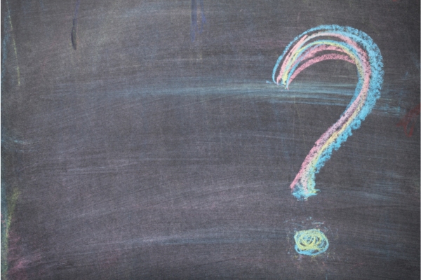 question mark written on a blackboard using colored chalk depicting FAQs about Air Leaks in House