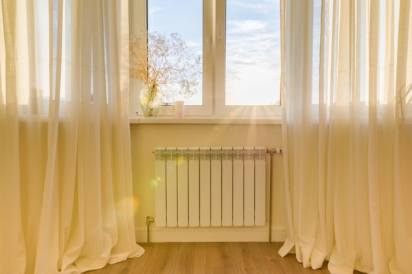 heating hot water radiator system under the window of a room