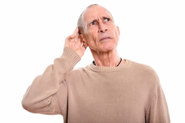 senior man cupping his ear identifying different furnace sounds