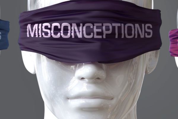 white mannequin blindfolded with MISCONCEPTIONS written on the blindfold