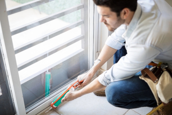 worker sealing glass door