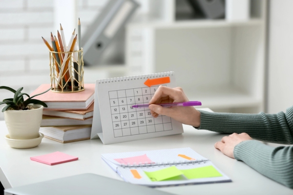 woman marking a date on a calendar depicting planning ahead for heating oil