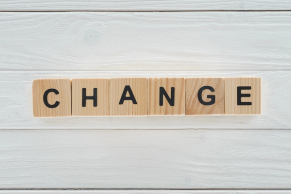 CHANGE word spelled using wooden letter cubes depicting Replace Aging Propane Equipment