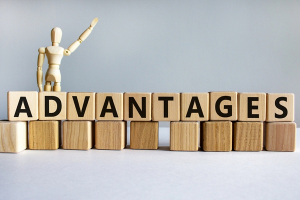 ADVANTAGES spelled using wooden letter cubes depicting Programmable Thermostat