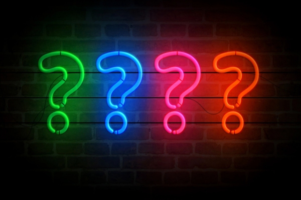 question marks formed using neon colored lights depicting How Does a Programmable Thermostat Work FAQs