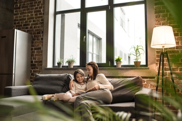 mom and daughter feeling cool and comfy indoors due to air conditioning