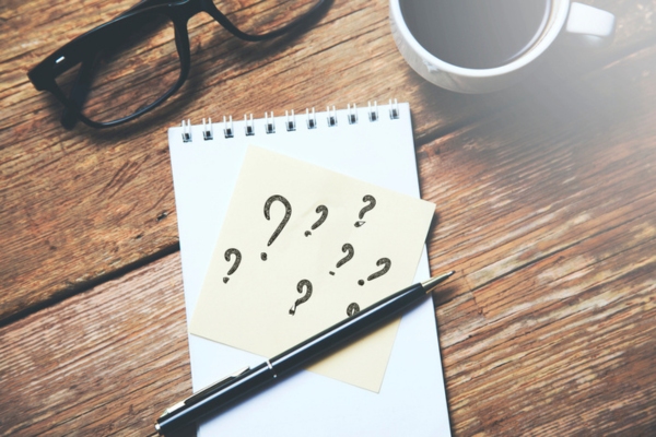 question marks on a sticky note depicting Oil Heating System Maintenance FAQs