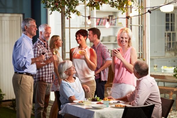 friends enjoying backyard party in summer