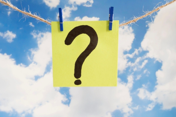 question mark written on paper hanging on a thin thread depicting Propane Outdoor Kitchen FAQs